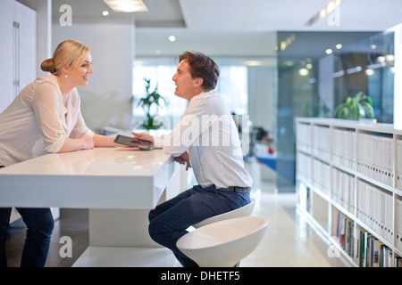 Businesspeople chatting in office Stock Photo