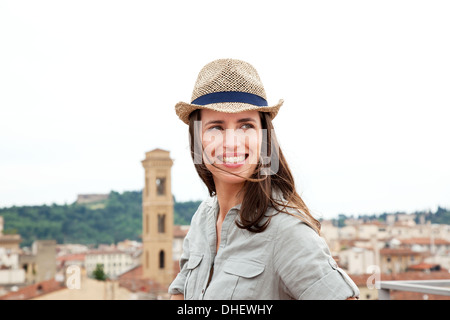 Young woman wearing straw hat, Florence, Tuscany, Italy