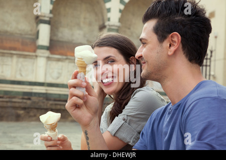 Couple eating ice creams, Santa Maria Novella square, Florence, Tuscany, Italy Stock Photo