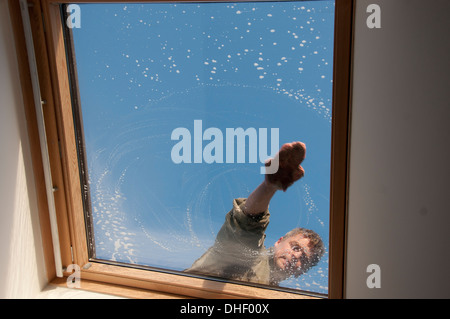Man cleaning roof window Stock Photo
