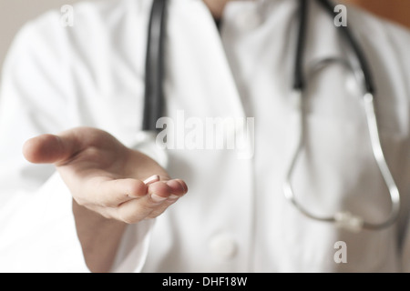Doctor holding pill Stock Photo
