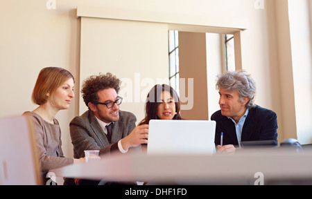 Office colleagues in meeting using laptop Stock Photo