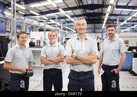 Portrait of manager and workers in engineering factory Stock Photo