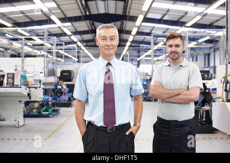 Portrait of manager and co-worker in engineering factory Stock Photo