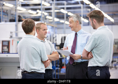 Workers and manager meeting in engineering warehouse Stock Photo