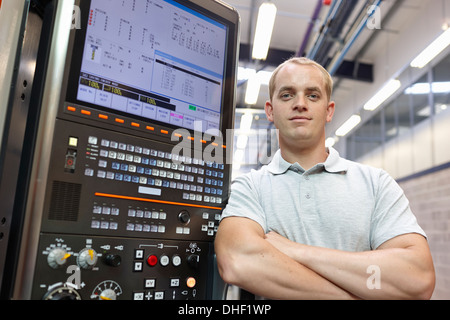 Portrait of engineer and control panel in engineering factory Stock Photo