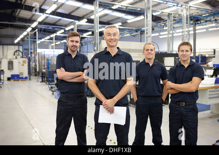 Portrait of four workers in engineering factory Stock Photo
