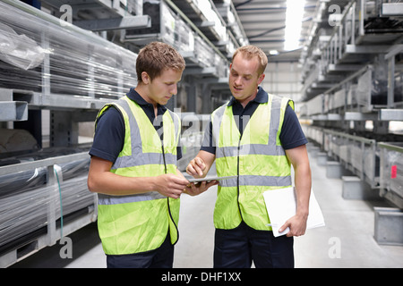 Workers checking orders in engineering warehouse Stock Photo
