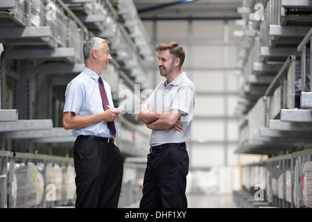 Worker and manager checking orders in engineering warehouse Stock Photo