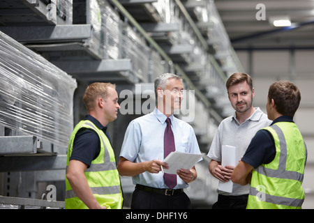 Warehouse workers and manager meeting in engineering warehouse Stock Photo