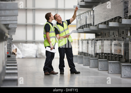 Warehouse workers checking shelves in engineering warehouse Stock Photo