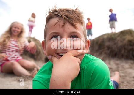 Portrait of boy with hand on chin smiling, Wales, UK Stock Photo