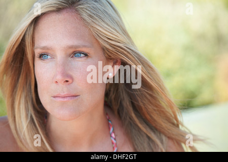 Portrait of mature woman with blonde hair, looking away Stock Photo