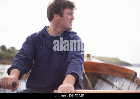 Portrait of man rowing in boat, Wales, UK Stock Photo