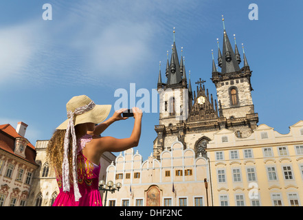 Teenage girl photographing Our Lady of Tyn church, Prague, Czech Republic Stock Photo