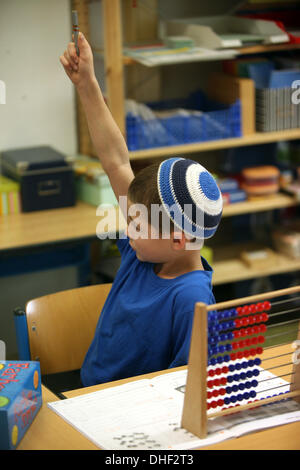 Math class at a school in Germany. A student solves a problem on the ...