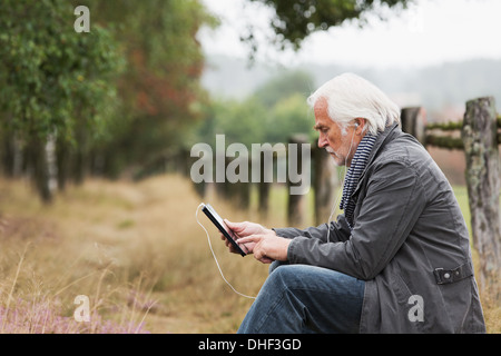 Senior man using digital tablet Stock Photo