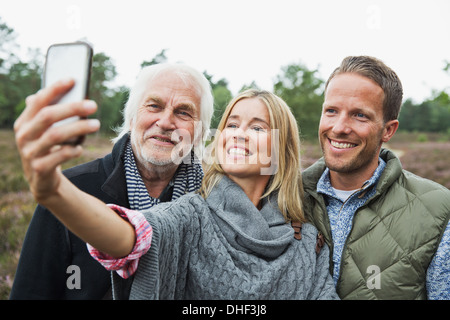 Mid adult woman taking photograph with camera phone Stock Photo