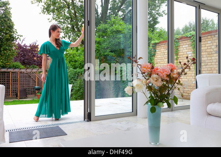 Young woman standing in patio dorrway Stock Photo