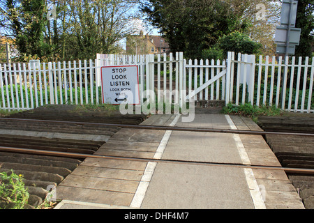 Warning Stop Look Listen Beware of Trains at unmanned railway crossing in the town of Rye in East Sussex, England UK Stock Photo