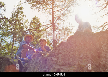 Family having picnic sitting on rocks Stock Photo