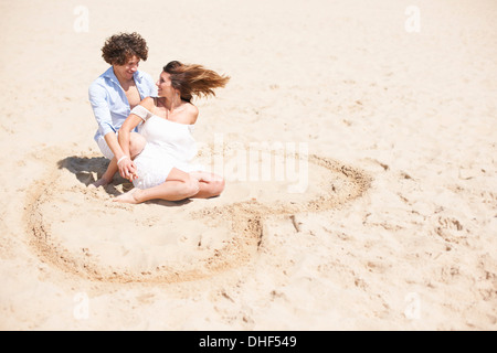 Couple relaxing on beach Stock Photo