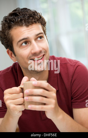 Young man taking coffee break Stock Photo