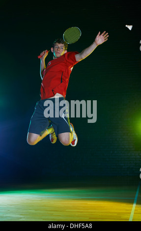Young male badminton player mid air on court Stock Photo
