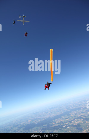 Skydivers free falling with air tube above Leutkirch, Bavaria, Germany Stock Photo