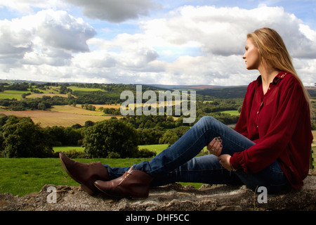 Portrait of young woman looking over rural landscape
