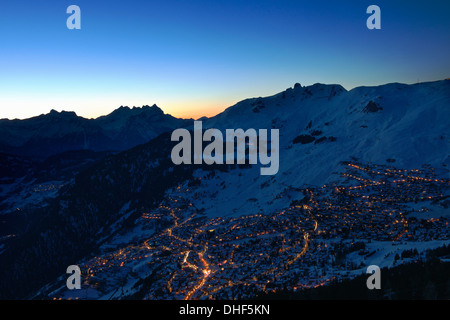 Town in mountains at night, Verbier, Switzerland Stock Photo