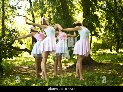 Four young ballet dancers performing in woods Stock Photo