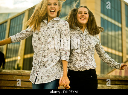 Two young women jumping Stock Photo