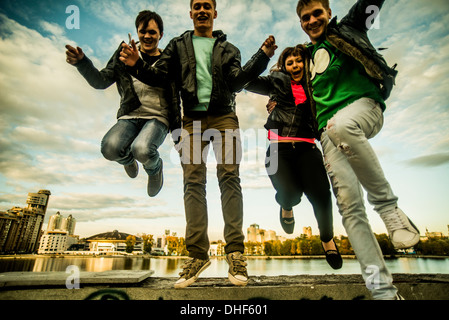 Four friends jumping mid air, Russia Stock Photo