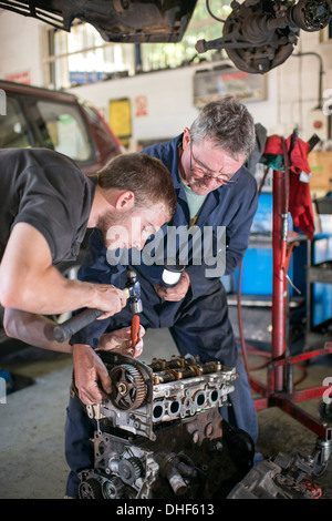 Mechanics working on car engine in garange Stock Photo