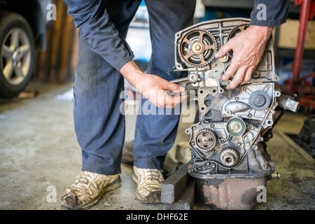 Mechanic working on car part Stock Photo