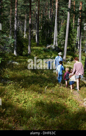 Family walking through forest Stock Photo
