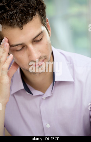 Young man in deep thoughts Stock Photo