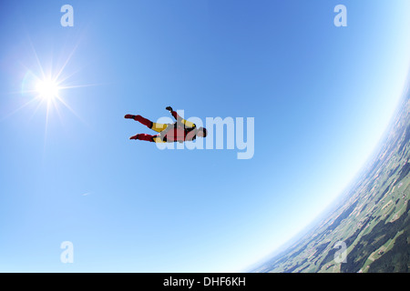 Skydiver free falling face down above Leutkirch, Bavaria, Germany