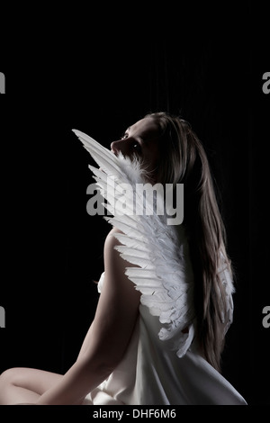 Studio portrait of graceful woman wearing angel wings Stock Photo
