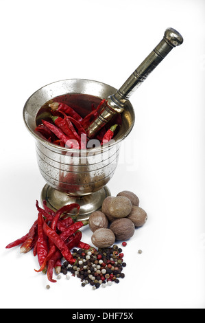 Mortar and pestle and some spices isolated in white background Stock Photo