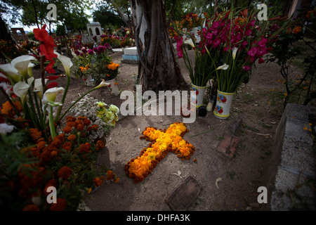 A cross made with marigold flowers decorate a grave during the Day of the Dead celebrations in Teotitlan del Valle,Oaxaca,Mexico Stock Photo