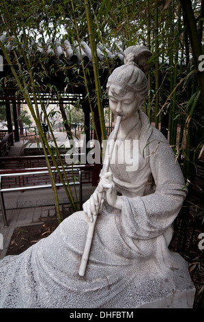 Statue of woman playing on chinese bamboo  flute in Zizhuyuan Park known as Purple or Black Bamboo Park in Beijing, China Stock Photo