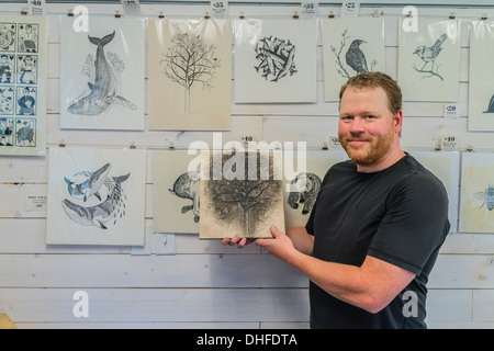 Artist Graham Blair, a woodblock printmaker holds an inked woodblock at his studio in Quidi Vidi in St. John's Newfoundland. Stock Photo