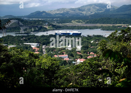 Ship passing through Pacific entrance to canal and Puente de las Americas as seen from Ancon Hill Panama city Republic of Panama Stock Photo