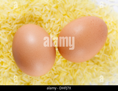 two chicken eggs on yellow rice, close up Stock Photo