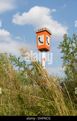 Emergency call post at a roadside in a rural landscape Stock Photo