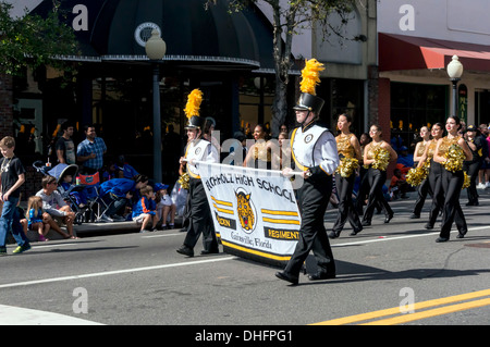 Buchholz High School marching band majors withbanner in yellow and black costumes marching in the UF 2013 Homecoming Parade. USA Stock Photo