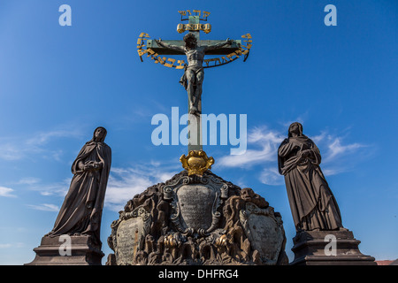 17th Century Crucifixion statue with Hebrew lettering in Charles Bridge Prague, Czech Republic Stock Photo