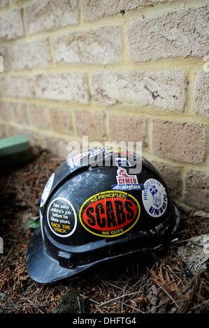 Construction worker's safety helmet covered in pro-Union, anti-scab-labour stickers. Stock Photo